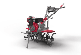 Red power tiller working in a farm field